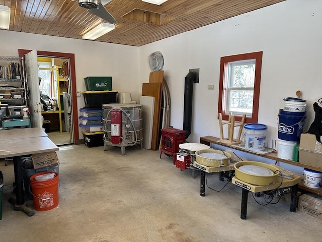 interior space featuring a wood stove and wooden ceiling