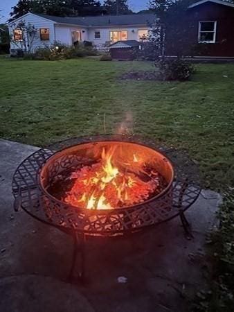 view of yard featuring an outdoor fire pit