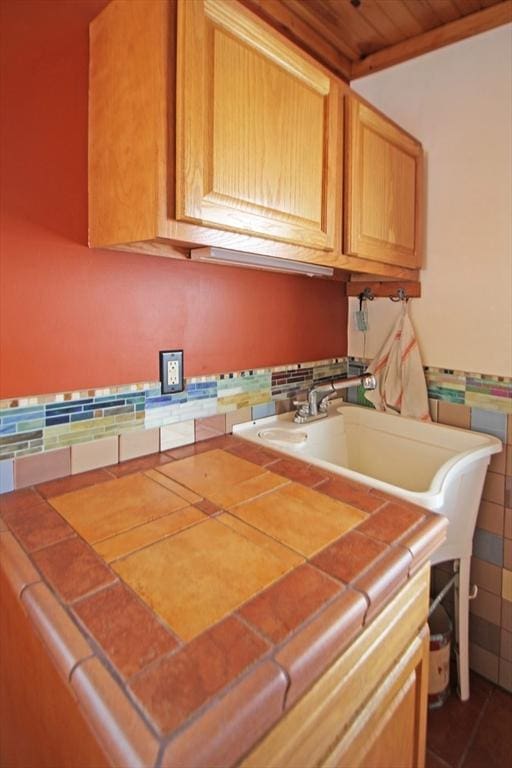 kitchen featuring a sink and tile counters