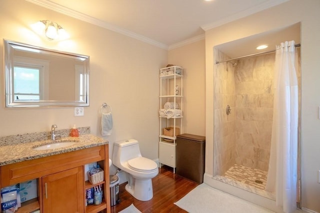 full bathroom with wood finished floors, a shower stall, ornamental molding, toilet, and vanity