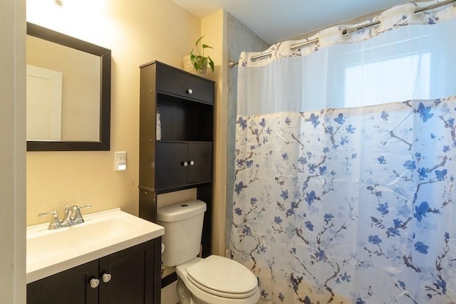 bathroom with toilet, vanity, and a shower with curtain