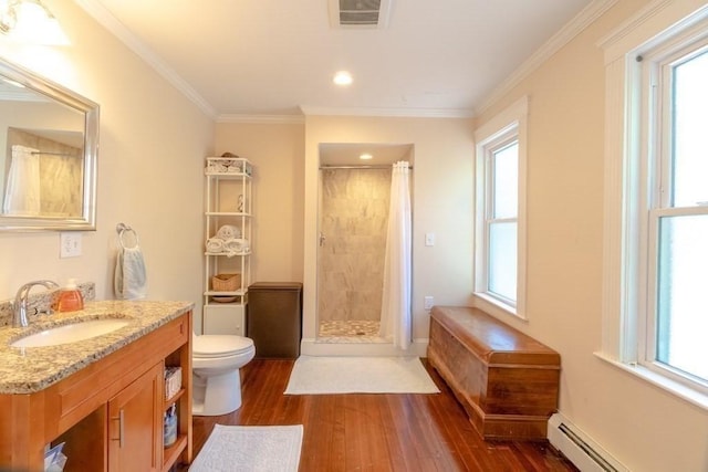 bathroom featuring baseboard heating, wood finished floors, a tile shower, toilet, and crown molding