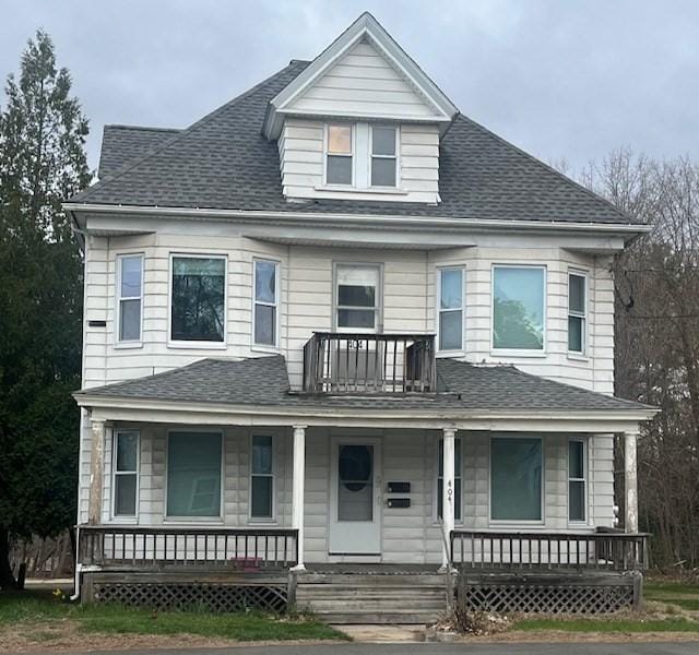 view of front of property with a shingled roof and a porch