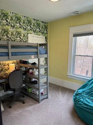 carpeted bedroom featuring baseboards and visible vents