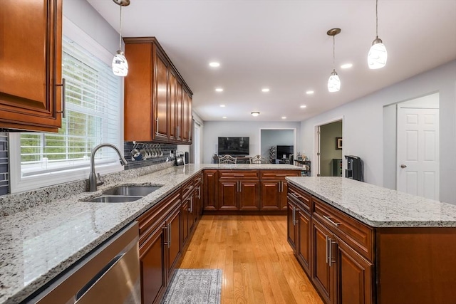 66 Eagle Dr, Dudley, MA 01571 - kitchen featuring a sink, stainless steel dishwasher, light wood-type flooring, light stone countertops, and hanging light fixtures