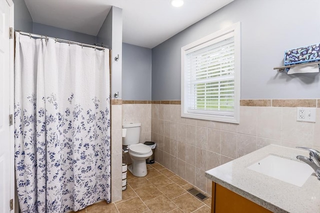 66 Eagle Dr, Dudley, MA 01571 - bathroom featuring toilet, vanity, tile walls, wainscoting, and a shower with shower curtain
