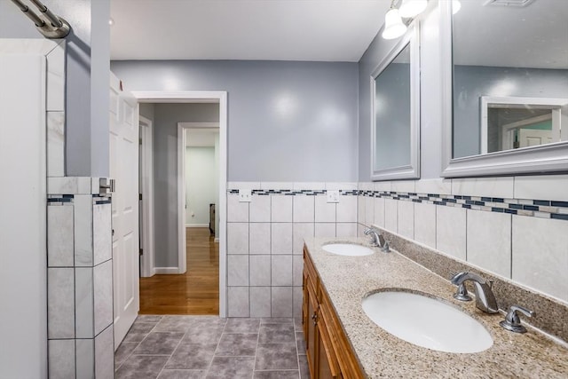 66 Eagle Dr, Dudley, MA 01571 - full bath with tile patterned flooring, double vanity, tile walls, and a wainscoted wall