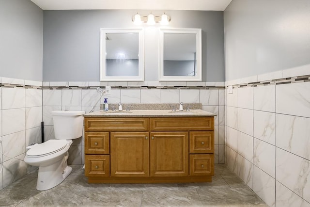 66 Eagle Dr, Dudley, MA 01571 - bathroom featuring tile walls, double vanity, toilet, and wainscoting