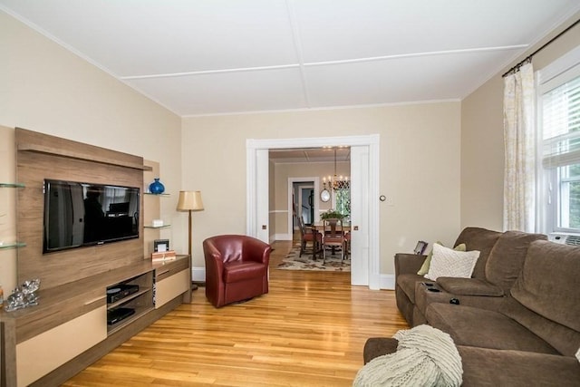 29-31 Bancroft Ave, Reading, MA 01867 - living room with light wood finished floors, a chandelier, and ornamental molding