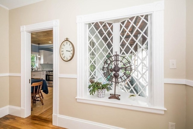 29-31 Bancroft Ave, Reading, MA 01867 - detailed view of wood finished floors, stainless steel range with gas stovetop, and ornamental molding