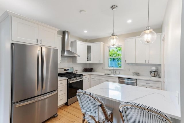 29-31 Bancroft Ave, Reading, MA 01867 - kitchen with stainless steel appliances, wall chimney range hood, tasteful backsplash, white cabinets, and recessed lighting