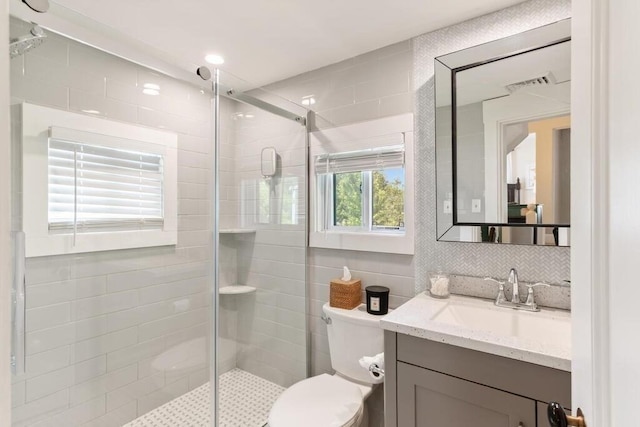29-31 Bancroft Ave, Reading, MA 01867 - full bathroom with a shower stall, vanity, tile walls, and decorative backsplash