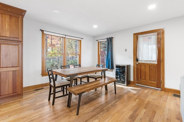 dining room featuring light hardwood / wood-style flooring and wine cooler