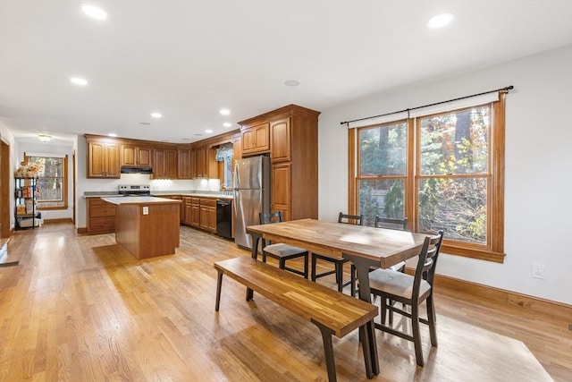 kitchen featuring a kitchen island, appliances with stainless steel finishes, and light hardwood / wood-style flooring