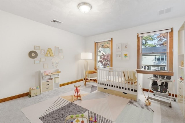 carpeted bedroom with a crib