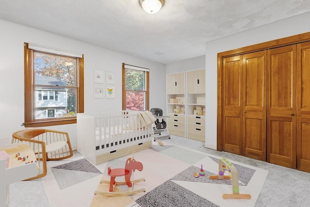 carpeted bedroom with a crib