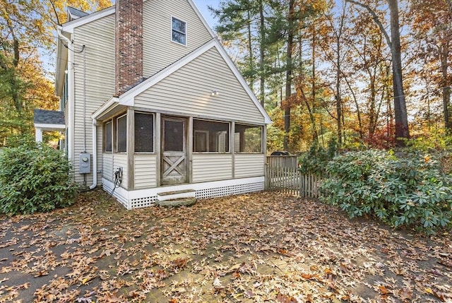 back of house featuring a sunroom