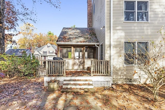 back of house with a sunroom