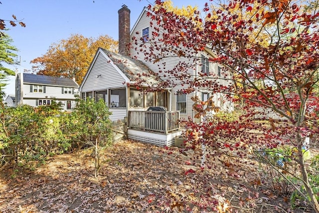 back of house featuring a sunroom