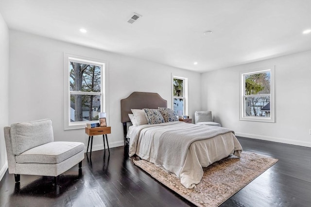 bedroom featuring multiple windows, dark wood-style flooring, baseboards, and recessed lighting
