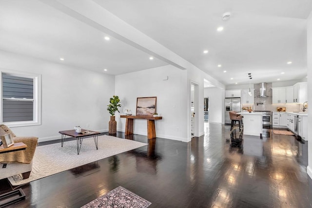 living room featuring dark wood-style flooring, recessed lighting, and baseboards