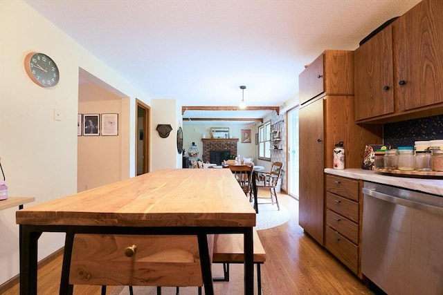 19 Hadley St Unit 14, South Hadley, MA 01075 - kitchen featuring dishwasher, brown cabinets, light wood-style flooring, and light countertops