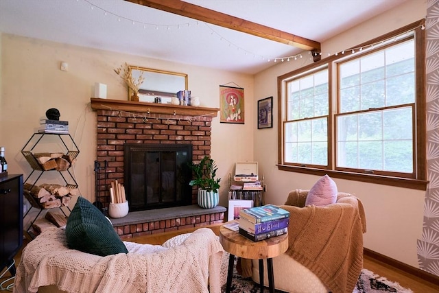 19 Hadley St Unit 14, South Hadley, MA 01075 - living room featuring healthy amount of natural light, wood finished floors, a fireplace, baseboards, and beamed ceiling