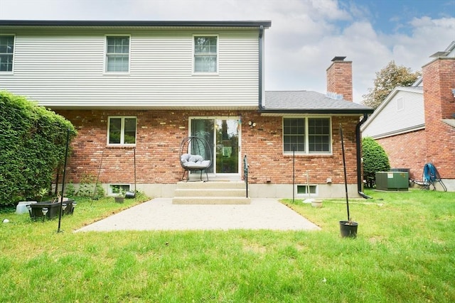 19 Hadley St Unit 14, South Hadley, MA 01075 - rear view of property with central air condition unit, a patio area, a yard, brick siding, and a chimney