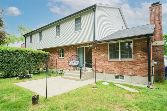 19 Hadley St Unit 14, South Hadley, MA 01075 - rear view of house with a lawn, a chimney, brick siding, and a patio area