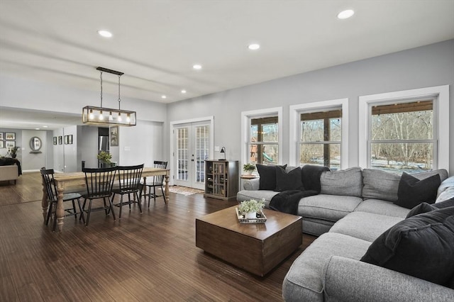 living room with dark wood finished floors, plenty of natural light, french doors, and recessed lighting