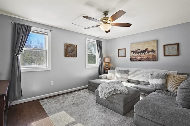 living room featuring ceiling fan, baseboards, and wood finished floors