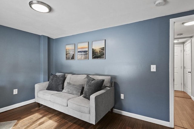 living area featuring baseboards and wood finished floors