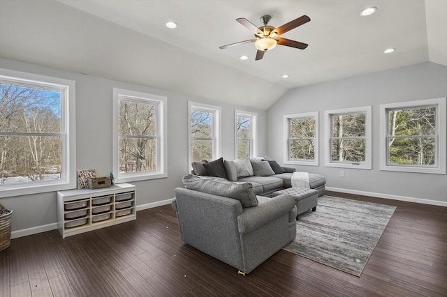 living area featuring plenty of natural light, lofted ceiling, and dark wood-style flooring