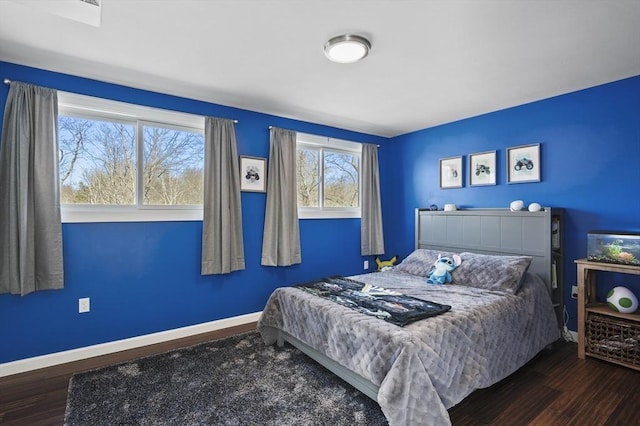 bedroom featuring baseboards and wood finished floors