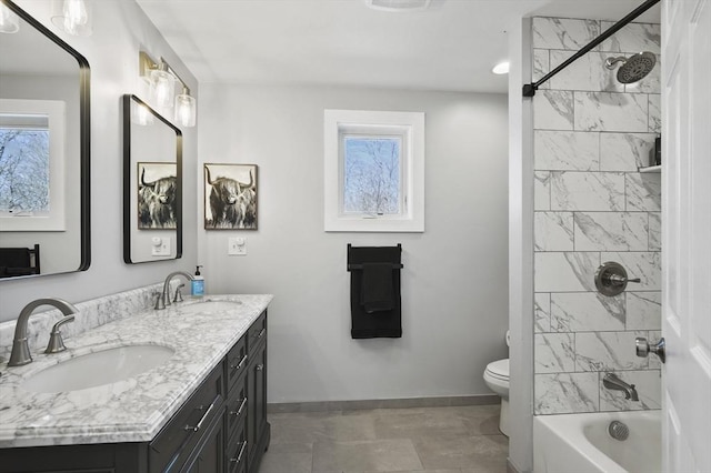 full bathroom with a sink, baseboards, and a healthy amount of sunlight