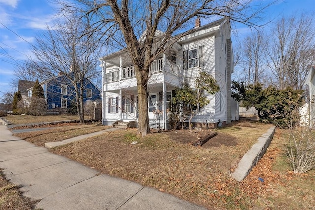 view of front of house featuring a balcony and covered porch