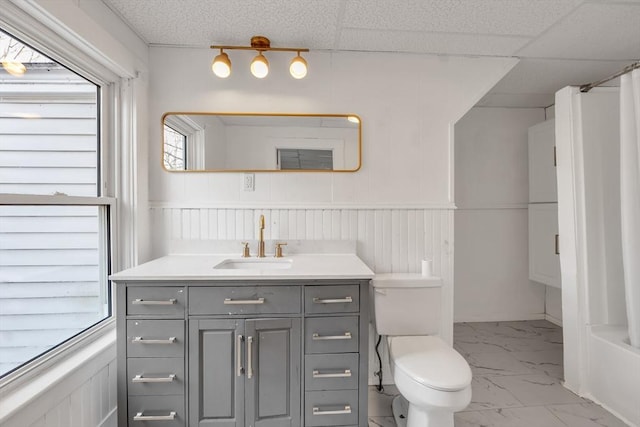 bathroom featuring a paneled ceiling, vanity, and toilet