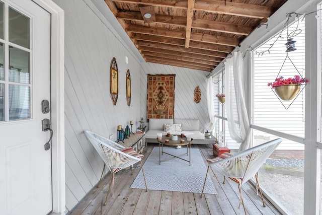 sunroom with vaulted ceiling with beams