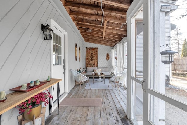 unfurnished sunroom with vaulted ceiling