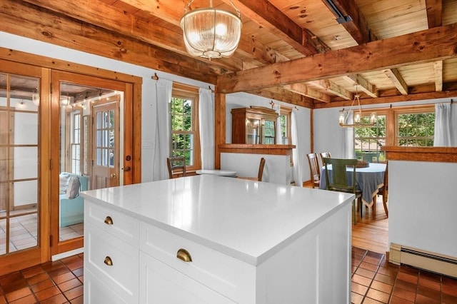 kitchen with white cabinets, wooden ceiling, a baseboard radiator, light countertops, and beam ceiling