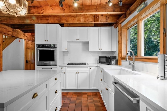 kitchen with white cabinets, wood ceiling, beam ceiling, black appliances, and a sink