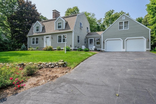 view of front of home featuring driveway, a garage, a gambrel roof, a chimney, and a front lawn