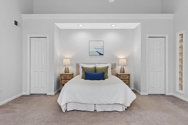 carpeted bedroom with baseboards, recessed lighting, multiple closets, and visible vents
