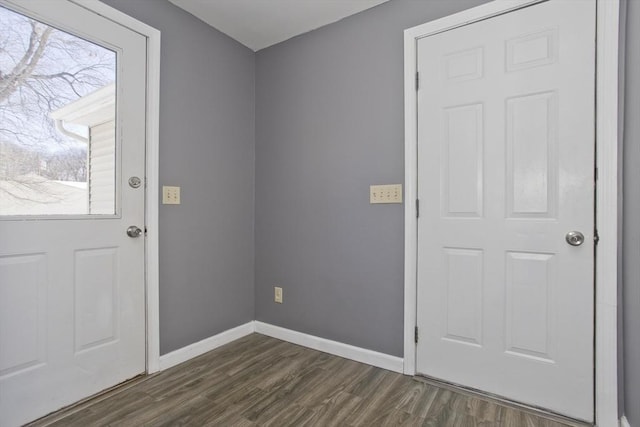 doorway to outside with dark wood finished floors and baseboards