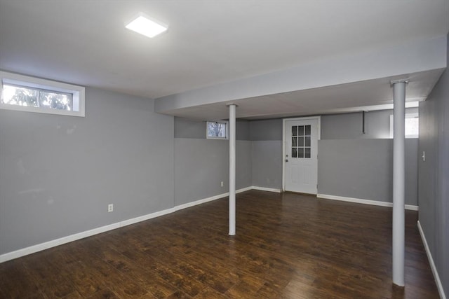 basement with baseboards and wood finished floors