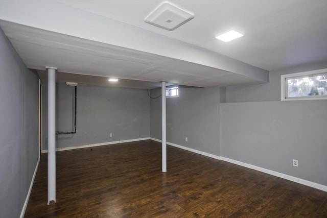 below grade area with baseboards and wood finished floors