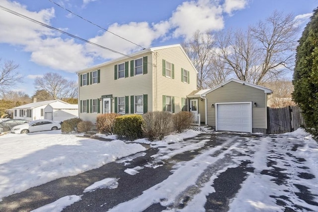 view of front of house featuring an attached garage and fence