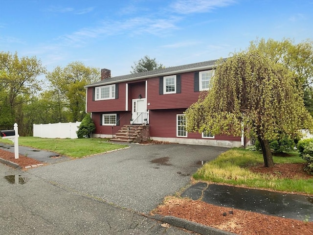 7 Nirvana Dr, Saugus, MA 01906 - bi-level home with a chimney and asphalt driveway