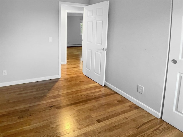 7 Nirvana Dr, Saugus, MA 01906 - empty room with baseboards, wood finished floors, and baseboard heating