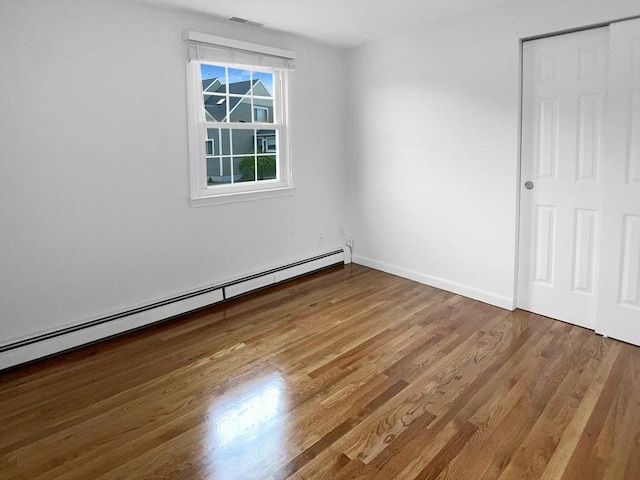 7 Nirvana Dr, Saugus, MA 01906 - unfurnished bedroom with a baseboard radiator, wood finished floors, and baseboards